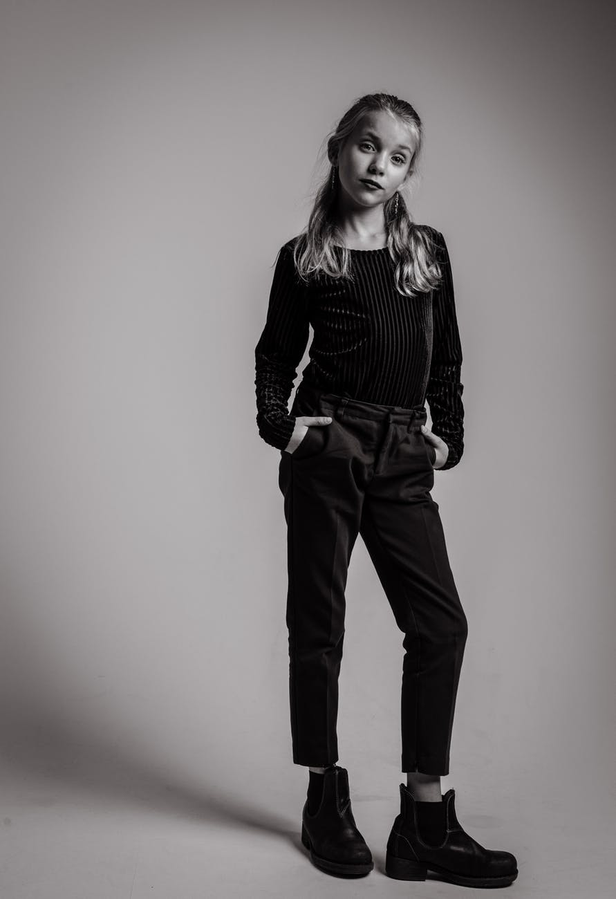 grayscale photography of girl in long sleeved top and jeans outfit